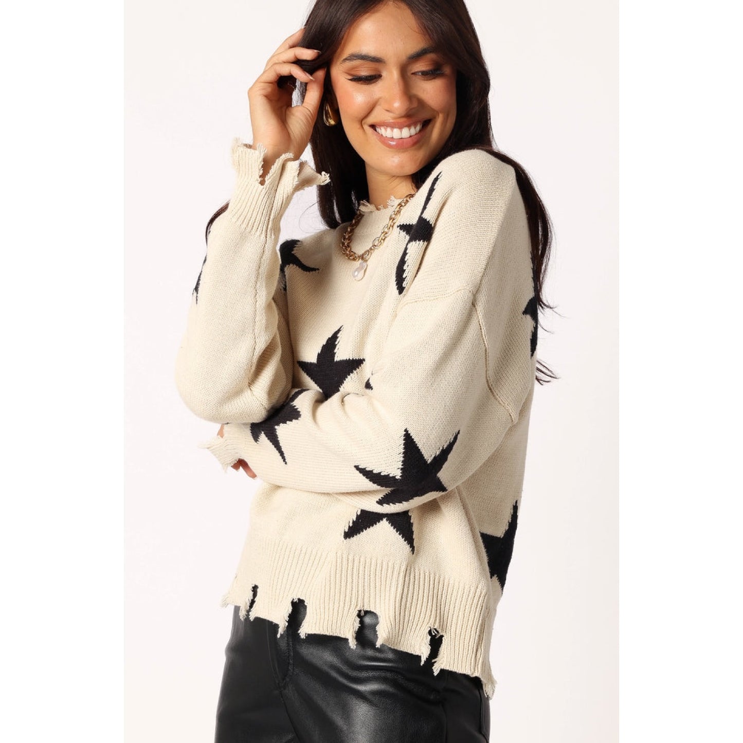 Knitted sweater with star print and distressed edges