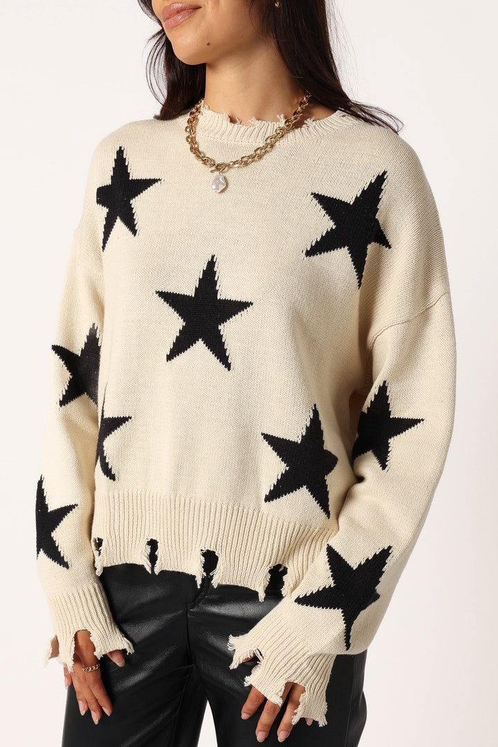 Knitted sweater with star print and distressed edges